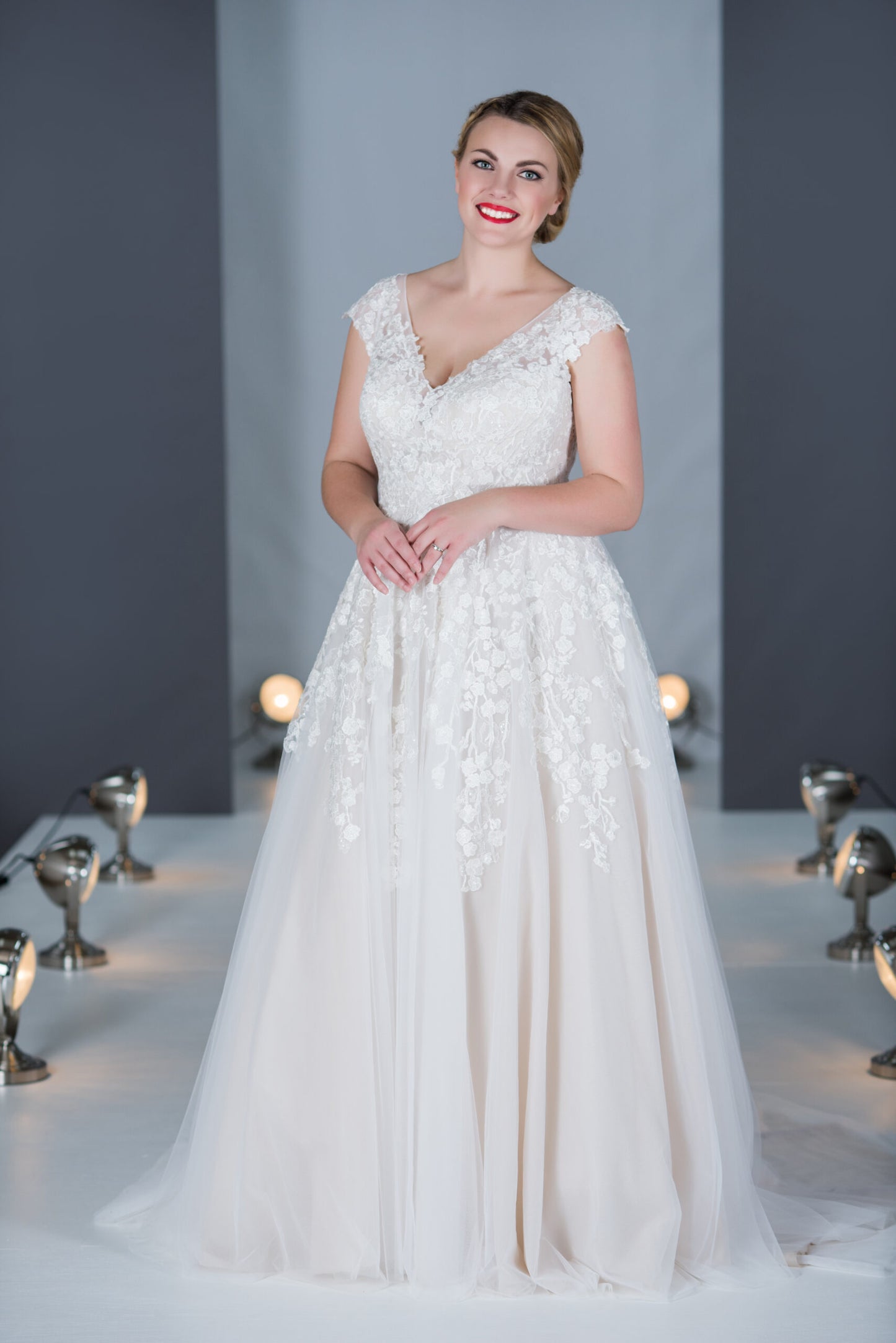 The Katherine tulle A-line gown with lace appliques. V neck with wide lace off shoulder straps.