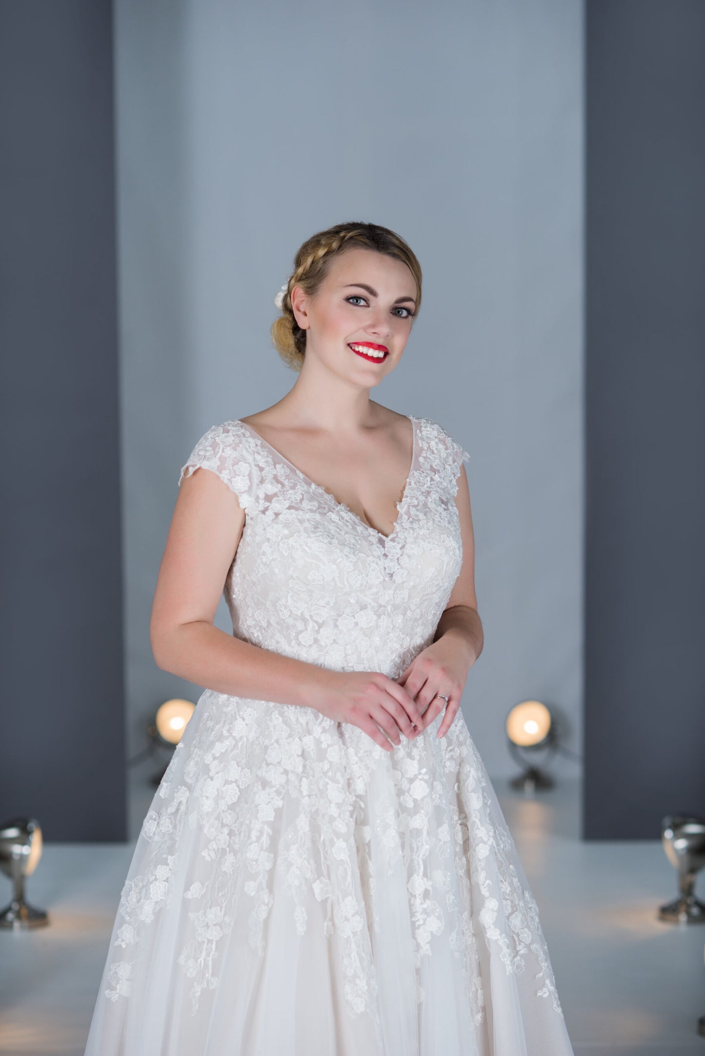 Close up of the Katherine tulle A-line gown with lace appliques. V neck with wide lace off shoulder straps.