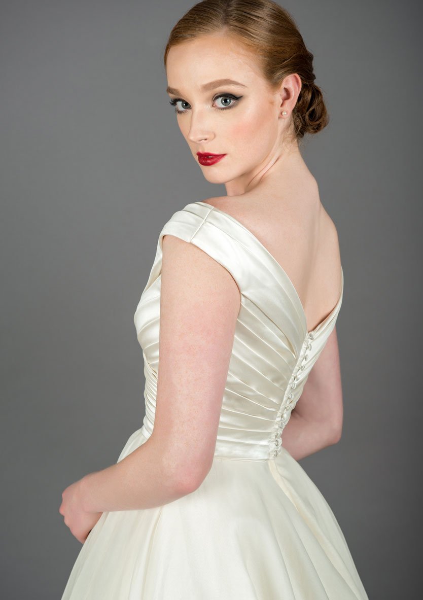 Button back satin bodice of the Annette tea length wedding dress