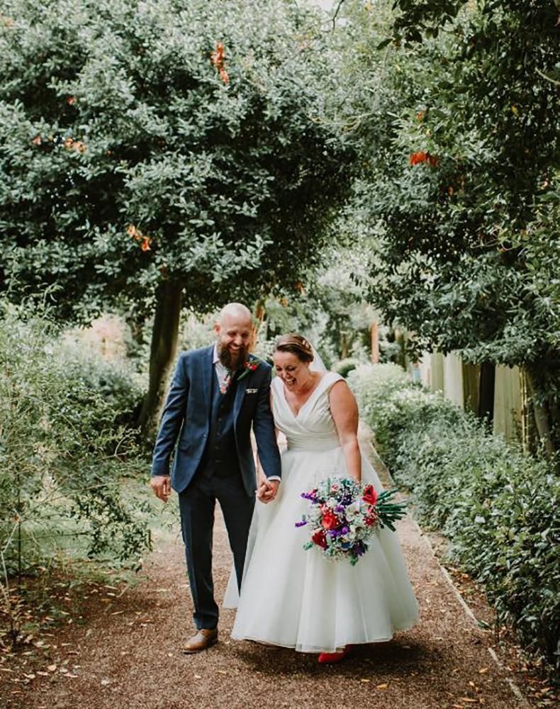 A happy bride in her Annette dress enjoying her day