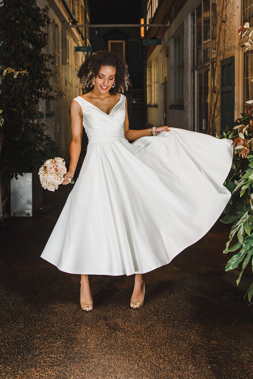 Marie is a tea length satin gown with pleats on bodice front & back. Dressed buttons over zip.