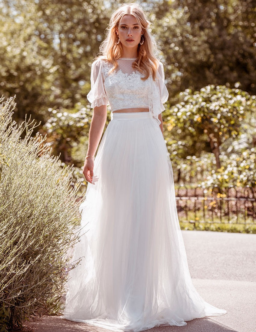 With spotty tulle and puff sleeve detail, this top is for the ultimate modern yet romantic bride. Layered lace appliques adorn the bodice and create the cutest illusion back detail. Teamed together with a soft tulle A-line skirt with a lace trim waistband, lined with Jersey for ultimate comfort, the two make the Rosa two piece wedding dress ensemble.