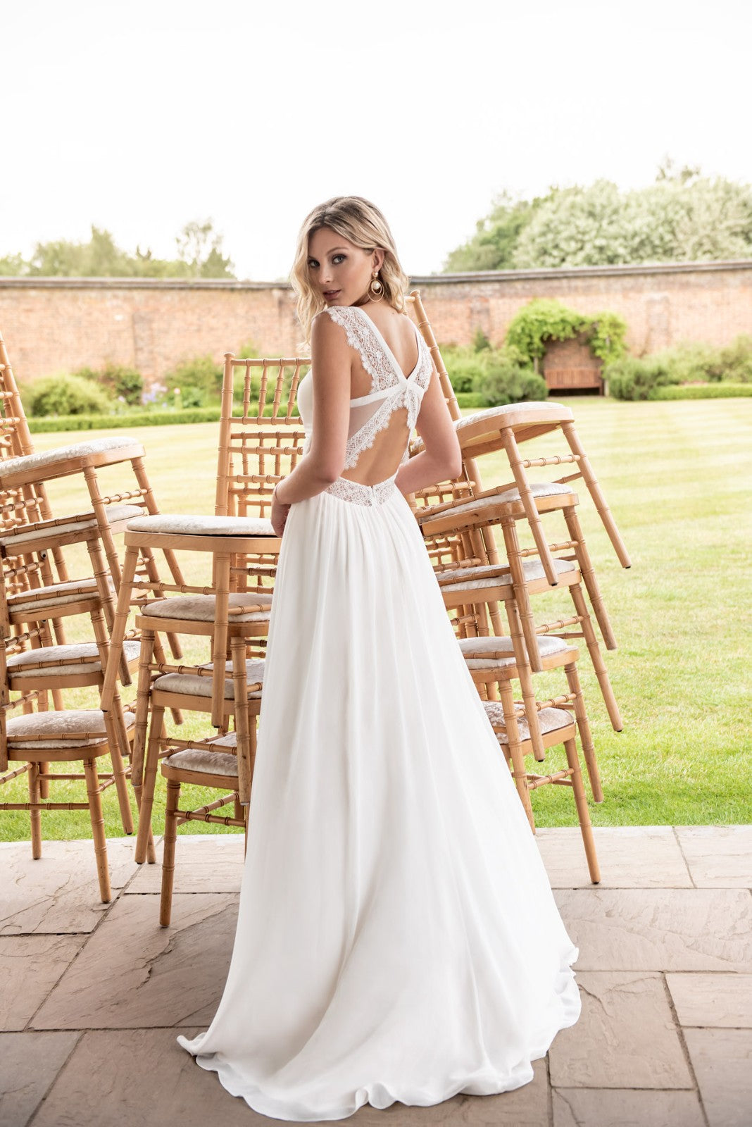 Back of ivory chiffon Empire line Dress with lace trim details at neckline & waist