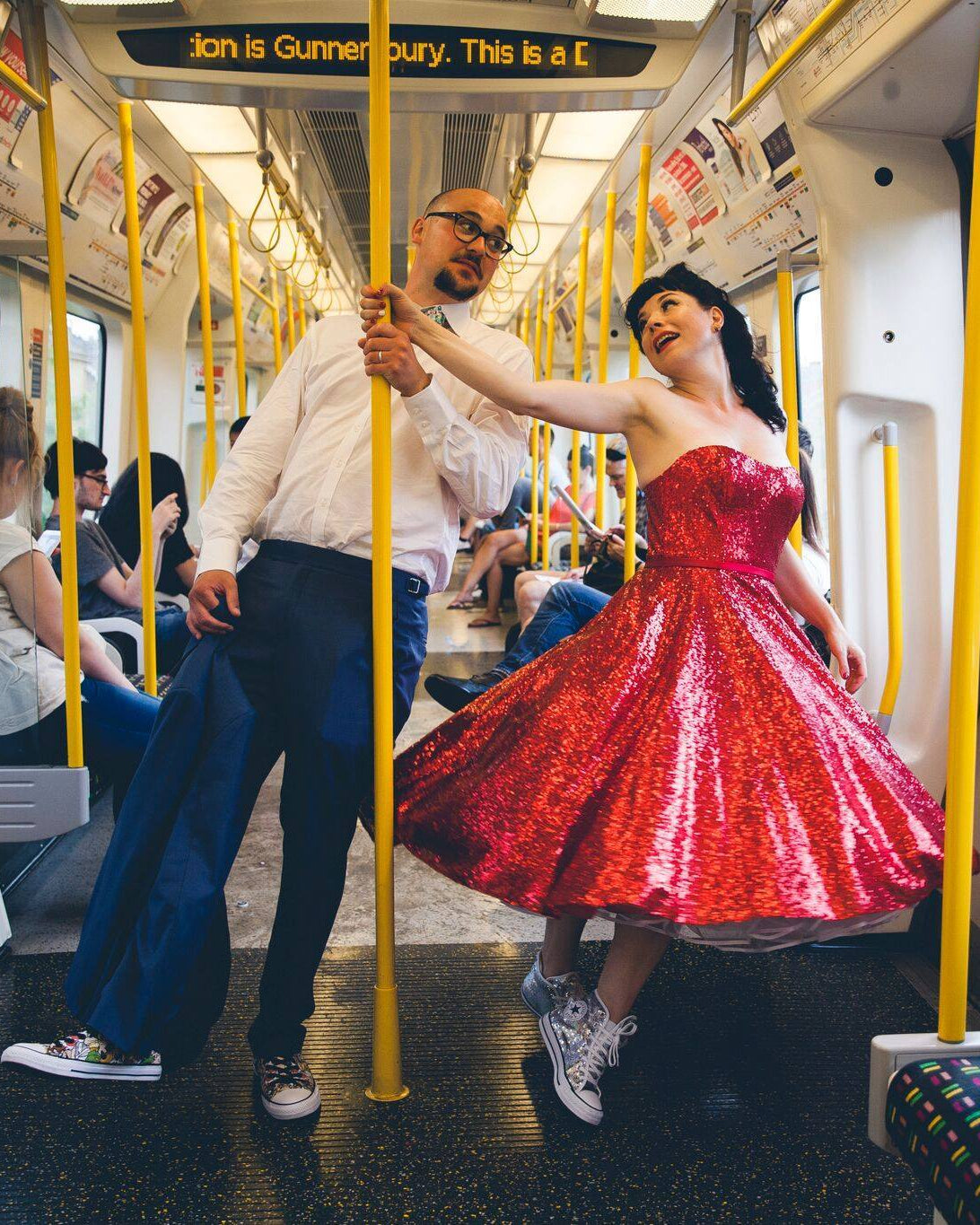 Real bride in a red sparkly tea-length wedding dress on London Tube