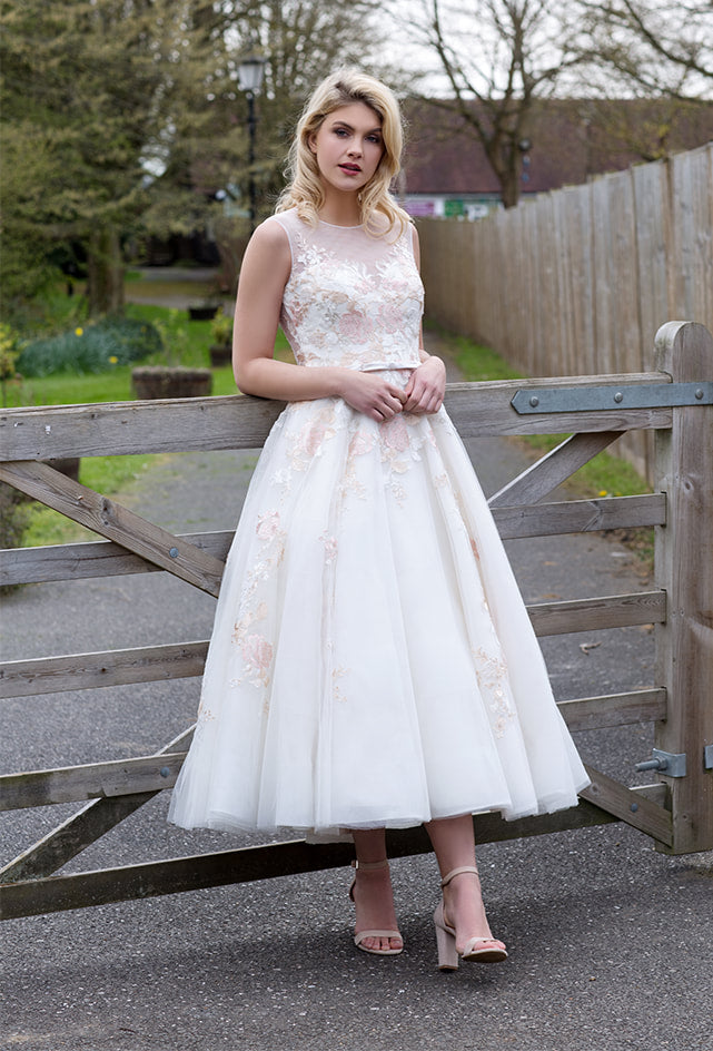 Tulle tea length wedding dress with floral appliques throughout bodice and skirt