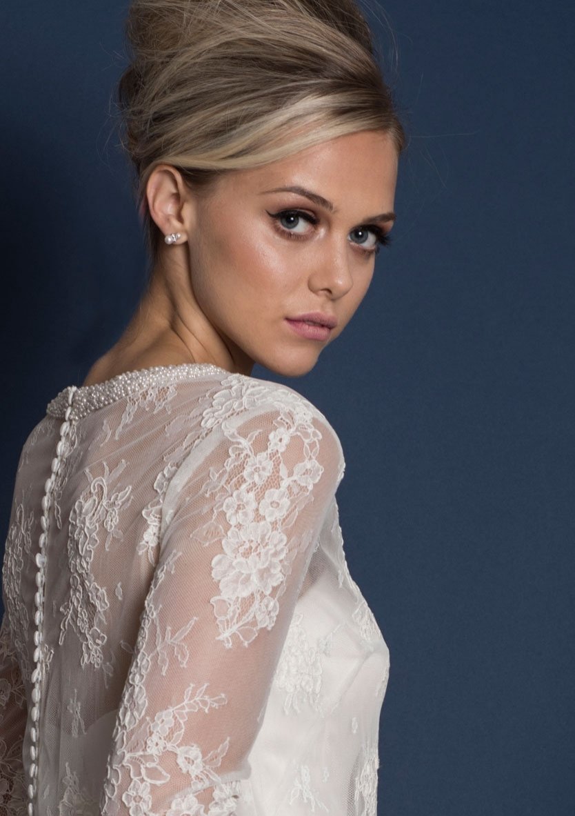 Closeup of Knee length classic 60's style silk duchess satin wedding dress