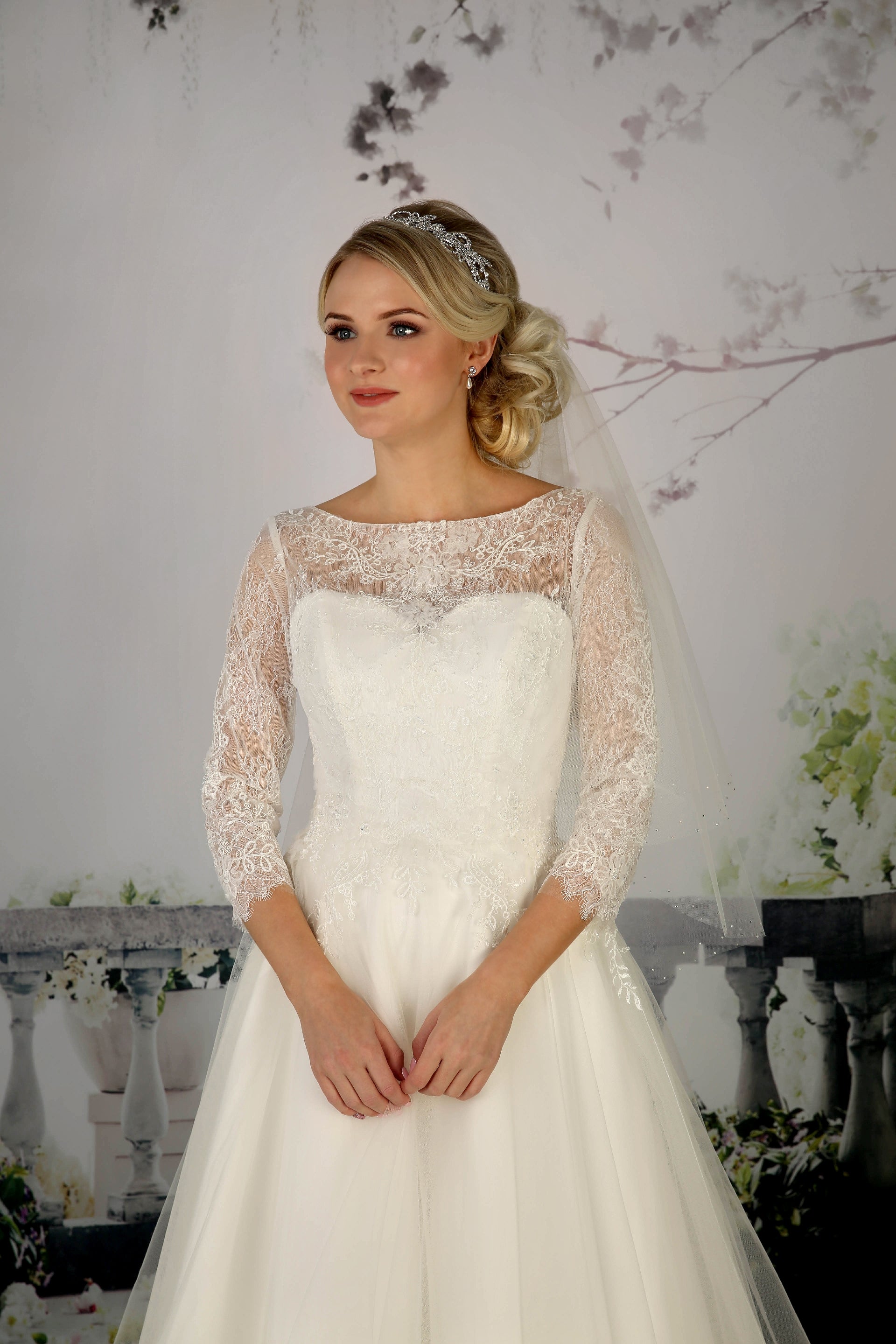 Close up of  the Cora's lace detail flowing onto a full tea length tulle skirt,