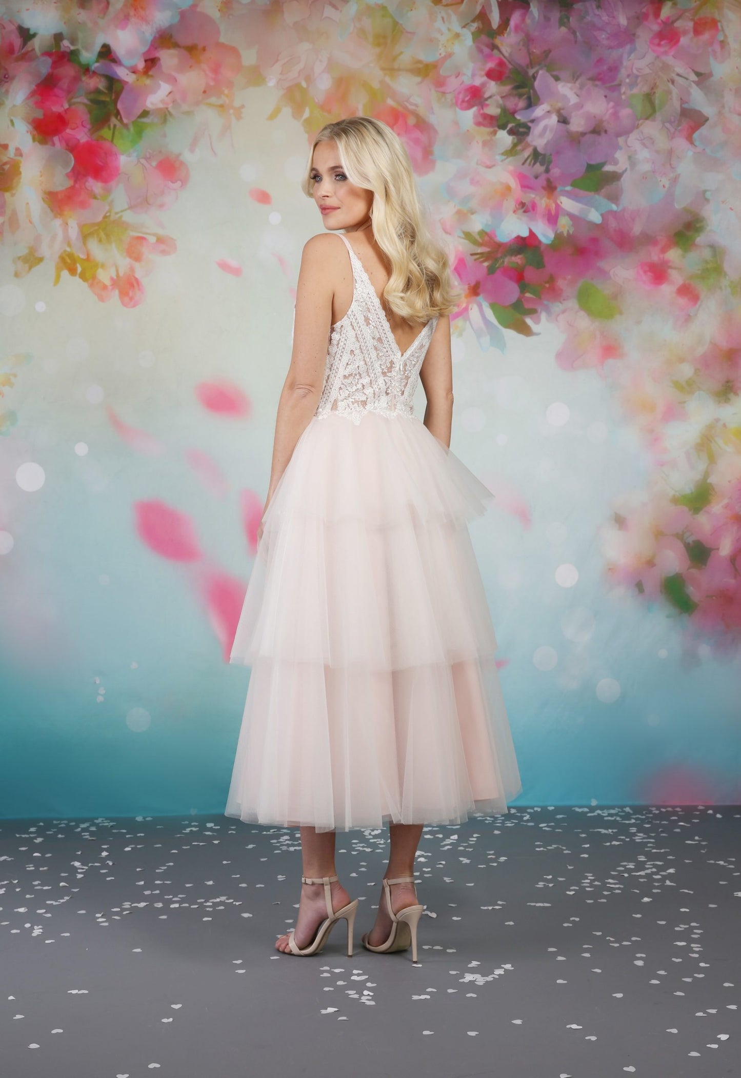 The back of the Iyla tea length wedding dress is decorated like the bodice but with a sheer effect so you can take advantage and admire the full design.   em-iyla