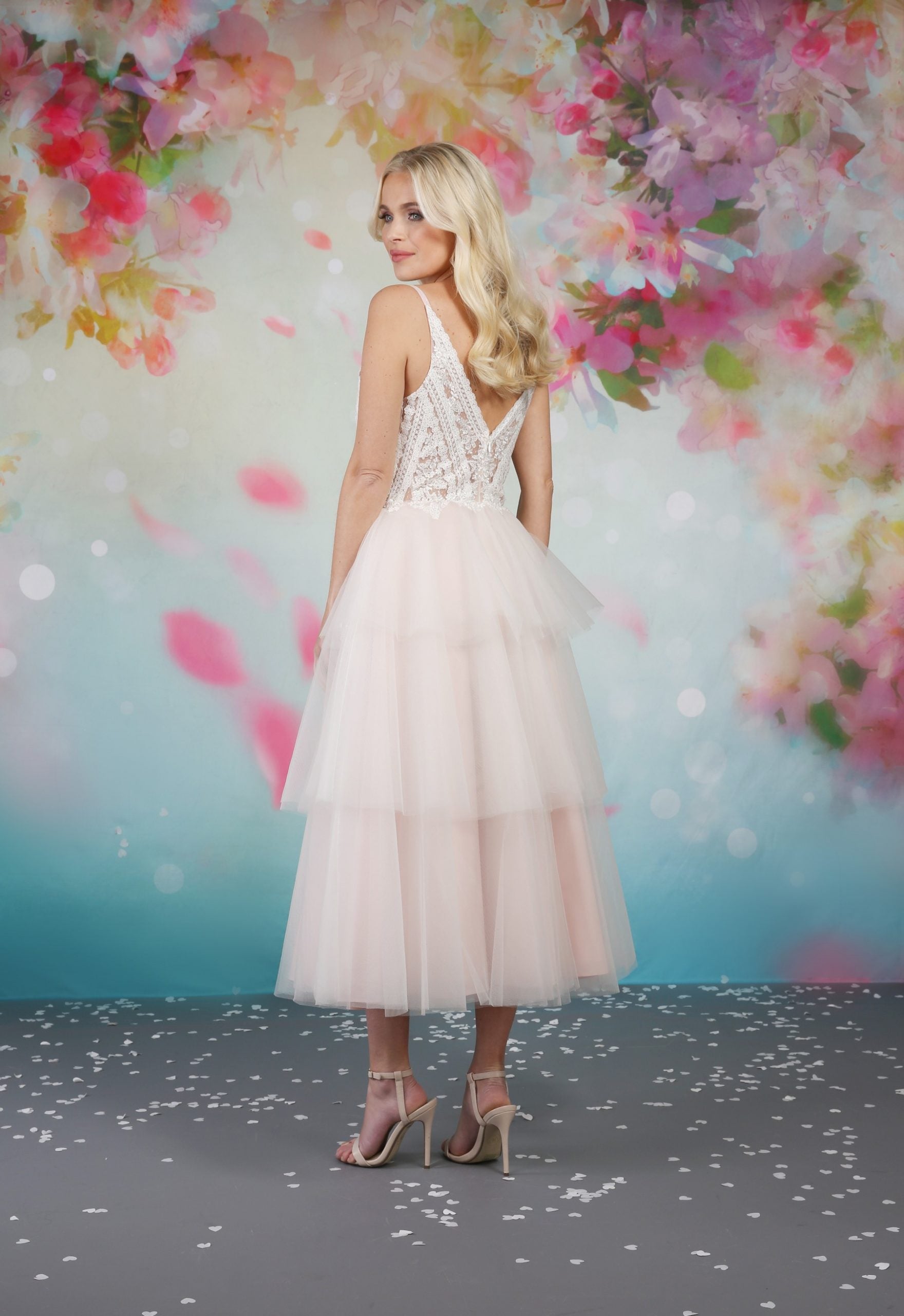 The back of the Iyla tea length wedding dress is decorated like the bodice but with a sheer effect so you can take advantage and admire the full design.   em-iyla