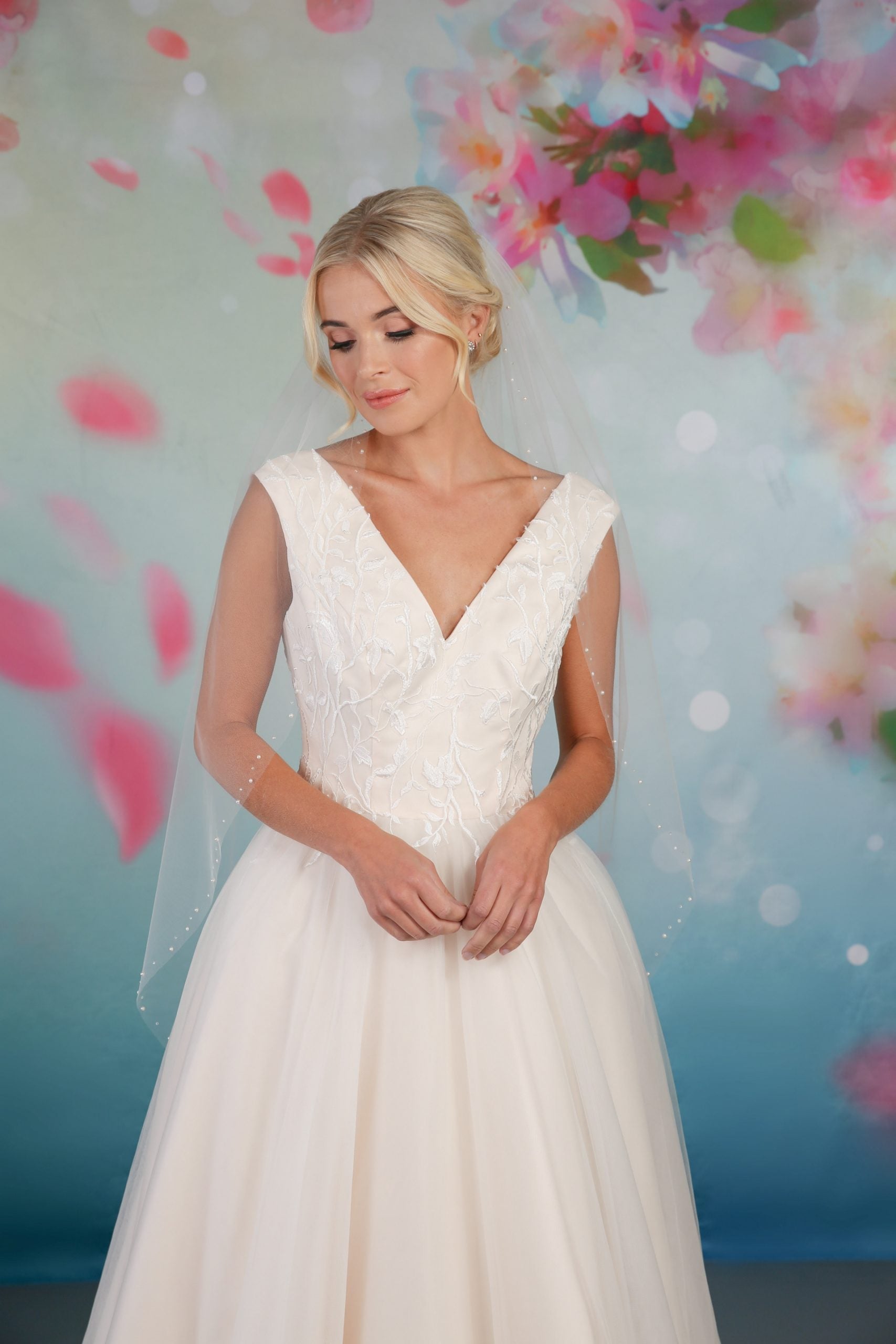 Close-up of the stunning tea-length bridal gown with a full tulle skirt, and gorgeous lace bodice  em-mabel