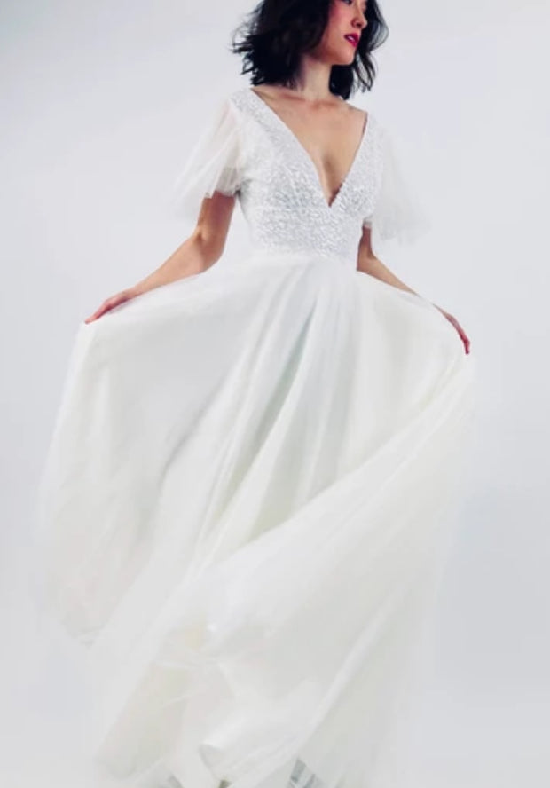 Full length wedding dress with a sheer sequined bodice, layered sleeves and full tulle skirt.  fb-nella