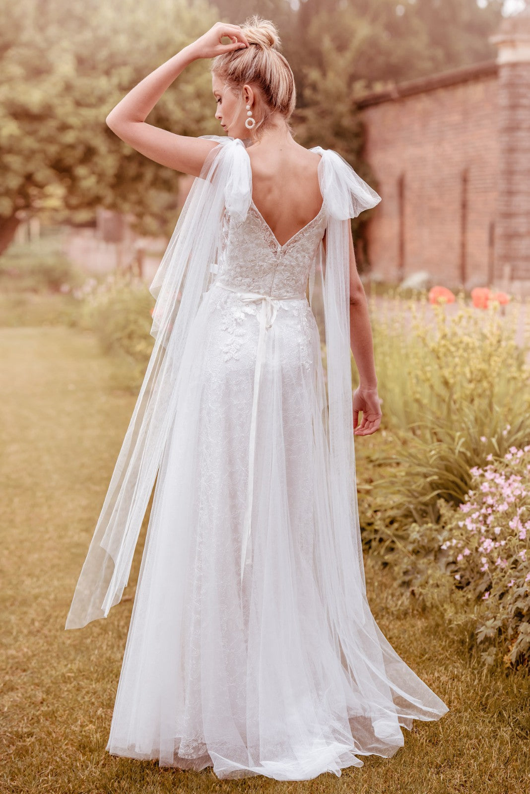 Back of  soft tulle is layered over sparkle Chantilly lace bridal gown
