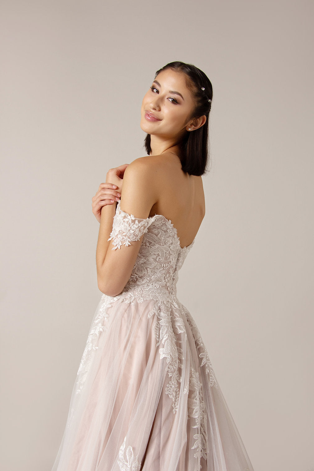 Closeup of the back of the Joni off-the-shoulder Boho ball gown with luxury lace bodice,  drop shoulder straps and zip back.