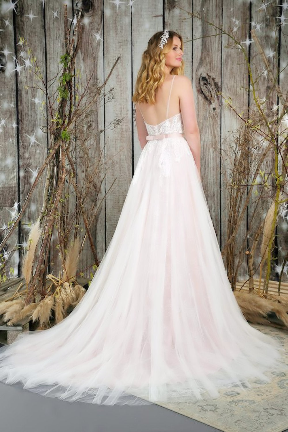Back and train of soft, flowing bridal gown with the most beautiful textures of lace and tulle