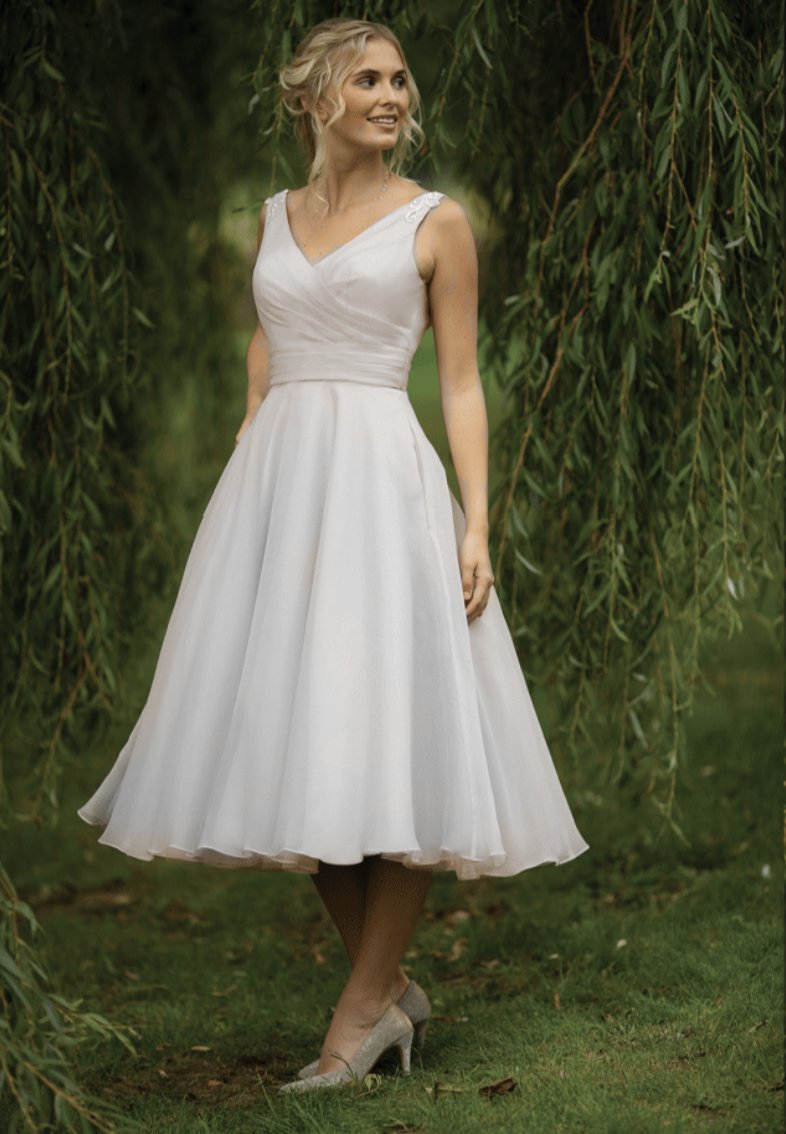 Vintage inspired  short 40's style wedding gown with fine appliqués to the shoulders, pleated fitted bodice and full 50's organza skirt